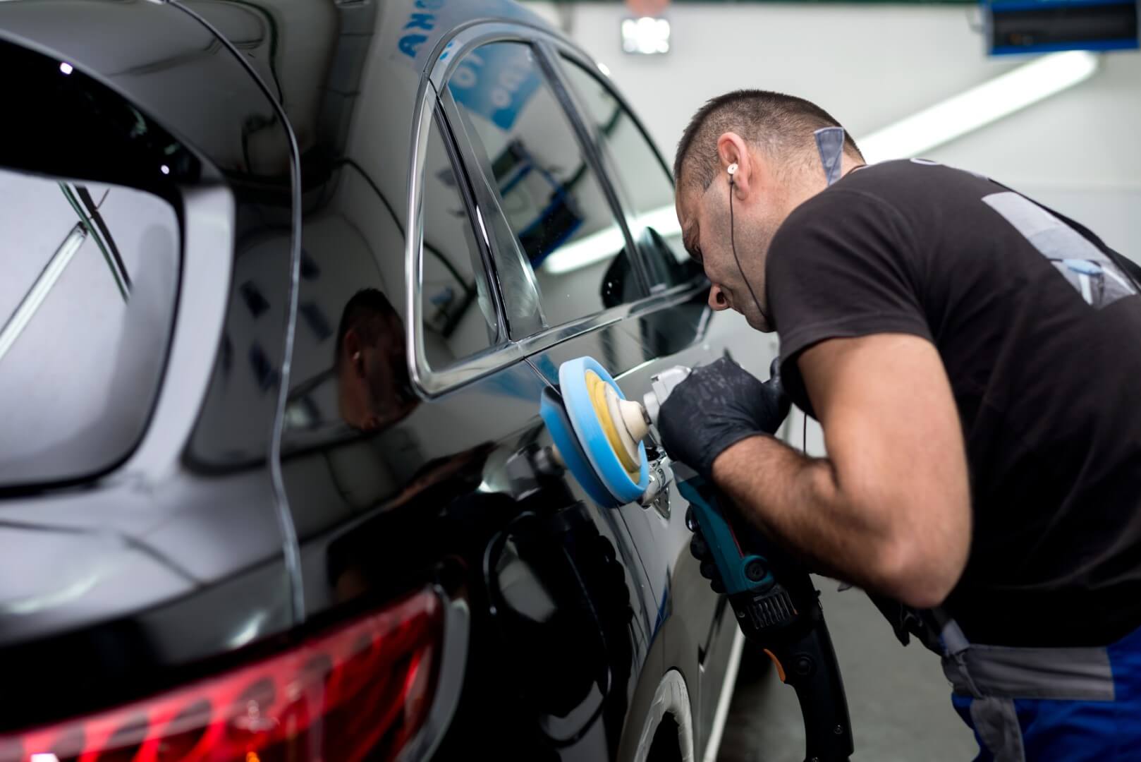 Car detailing expert from Kleinburg waxing a car.